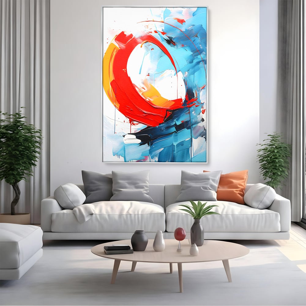 Tablou canvas cu pictura abstracta cu cerc rosu si tuse albastre, in rama de aluminiu argintiu, pe perete intr-un living